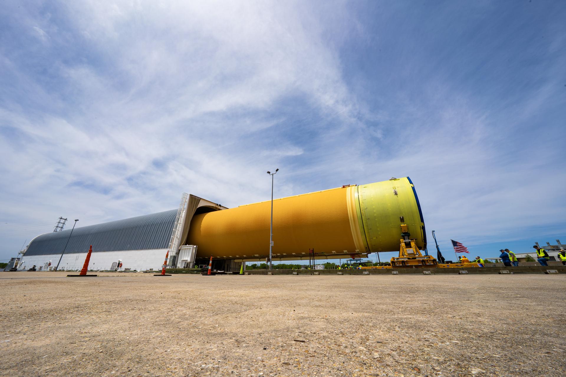NASA moved the core stage, or the largest section, of the SLS (Space Launch System) rocket that will launch the crewed Artemis III mission in 2027 from the agency’s Michoud Assembly Facility to the agency’s Pegasus barge in New Orleans on April 20. The barge will ferry the top four-fifths – the section containing the liquid hydrogen tank, liquid oxygen tank, intertank, and forward skirt – of the SLS core stage to NASA’s Kennedy Space Center in Florida to complete outfitting and vertical integration.  Teams with NASA and Boeing, the SLS core stage lead contractor, used specialized transporters to guide the top four-fifths from the NASA rocket factory to Pegasus. Prior to the move, technicians added an engine section transportation simulator to the rocket stage for shipment to the Space Coast.  Next year’s Artemis III mission will launch astronauts to Earth’s orbit aboard the Orion spacecraft on top of SLS to test rendezvous and docking capabilities between Orion and commercial spacecraft needed to land Artemis IV astronauts on the Moon in 2028. NASA’s SLS is the only rocket capable of sending Orion, astronauts, and supplies to the Moon in a single launch. 
